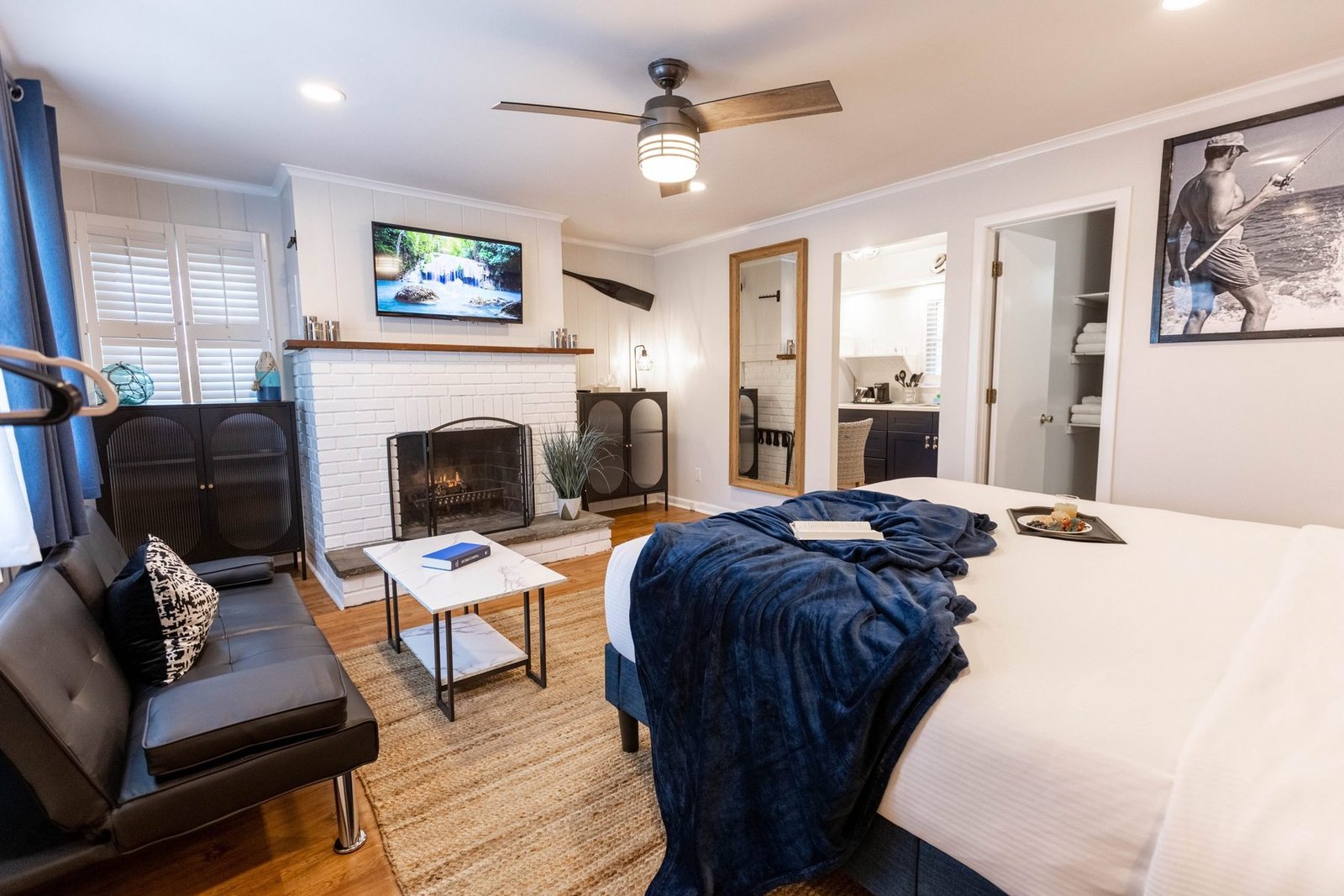 King Deluxe Suite at Ocean View Terrace Inn featuring king bed, decorative fireplace, and full kitchen, Hampton Bays, NY